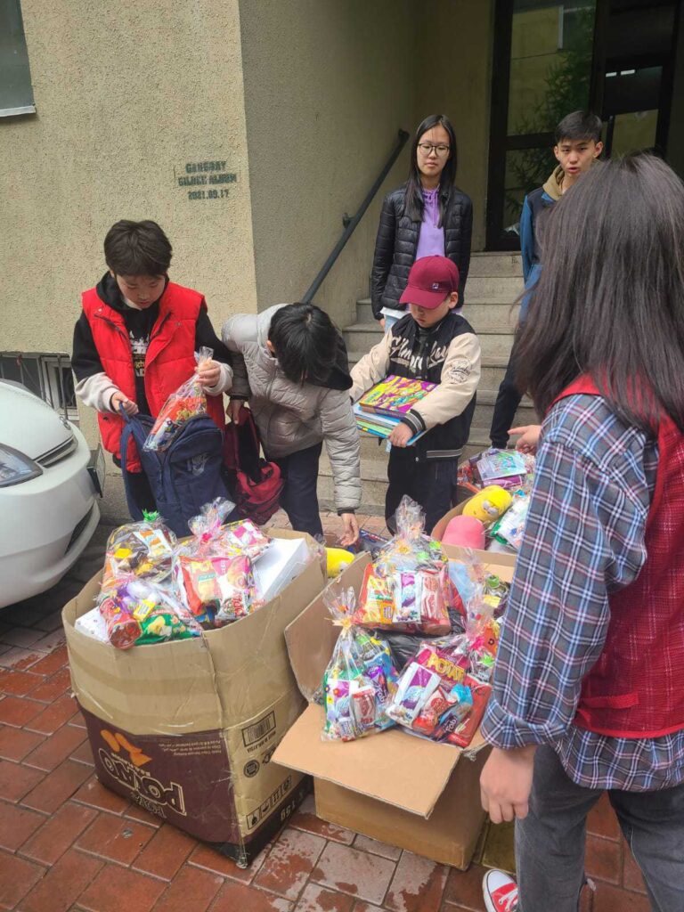 Volunteers box up donations for Mongolia children on International Children's Day.