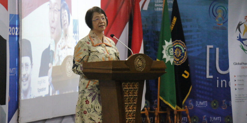 A woman presents at GPF Indonesia's UGen Seminar, discussing Pancasila and Global Peace.
