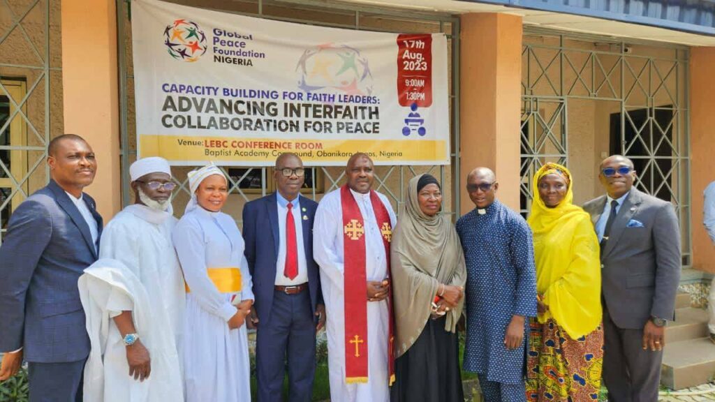 A diverse group of faith leaders standing in front of a building during the Global Peace Foundation's Transformative Interfaith Engagement Training.