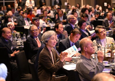 A group of people clapping at the International Forum on One Korea 2023 in Seoul, South Korea.