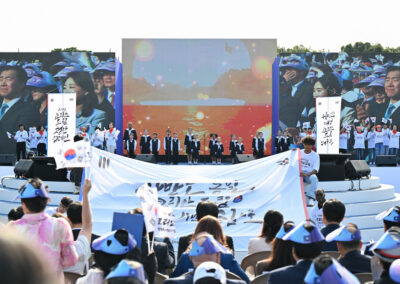 A group of people holding a banner in front of a stage.
