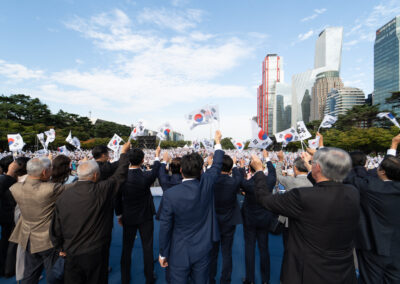 A group of people waving flags.