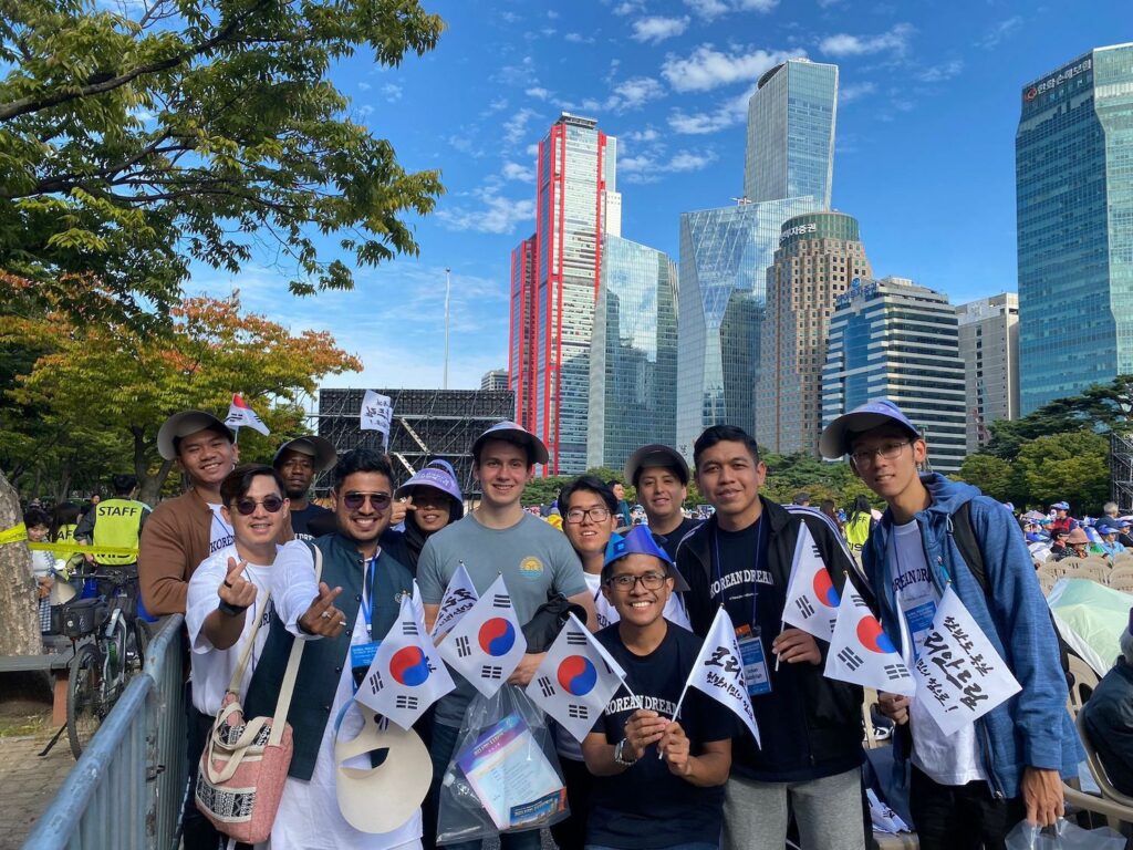 Bridging Boundaries: A group of people posing for a photo with Korean flags during Global Peace Foundation in Seoul.