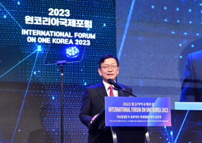 A man speaking at a podium during the International Forum on One Korea 2023 held in Seoul.