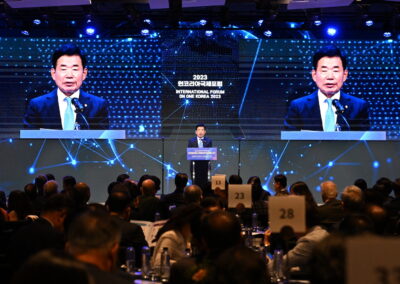 A man in a suit is speaking at the International Forum on One Korea 2023 held in Seoul.