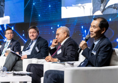 International Forum on One Korea 2023 Held in Seoul, South Korea: A group of men in suits sitting on chairs at a conference.