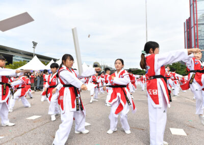 A group of people in red and white taekwondo uniforms.