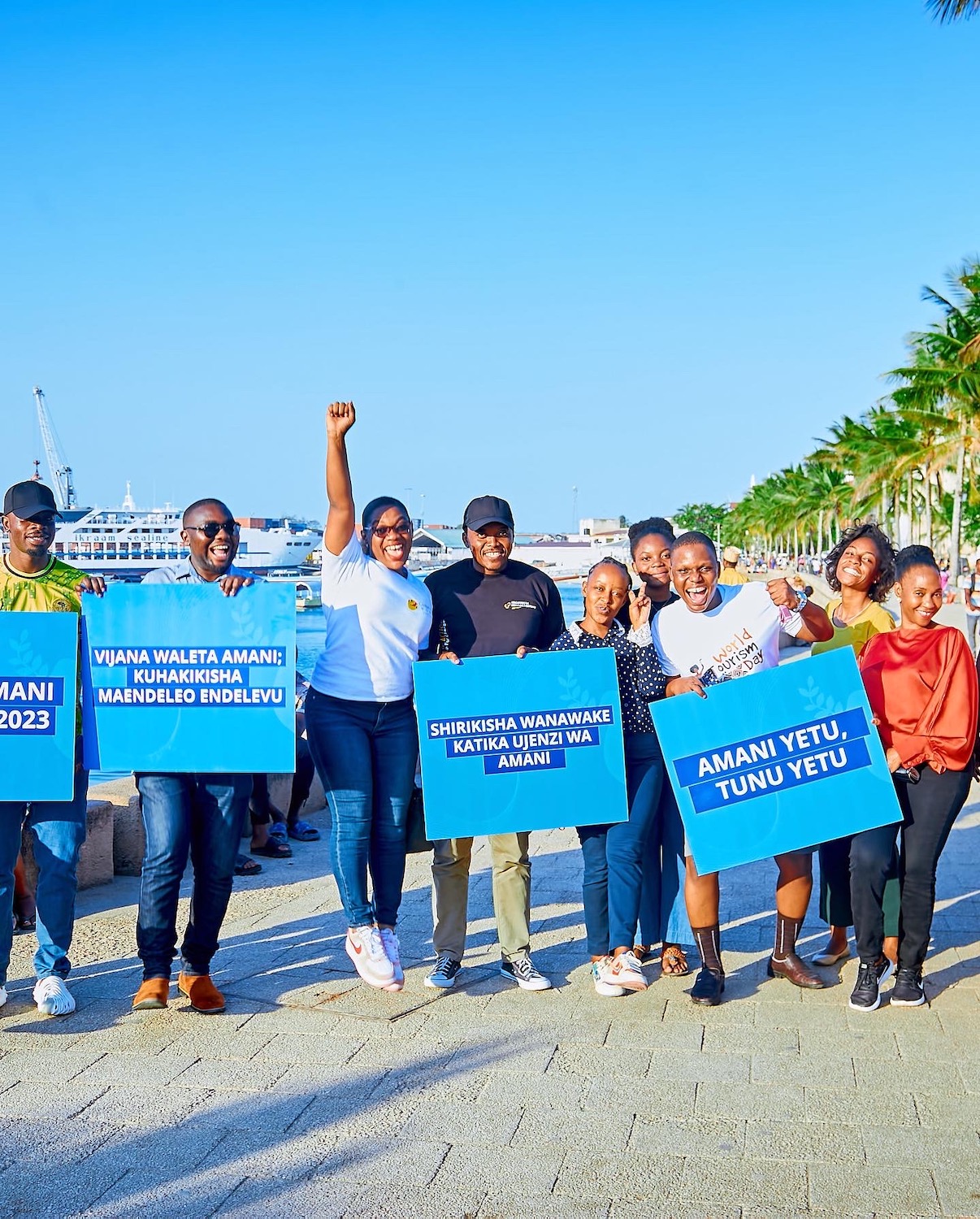 A group of people holding blue signs in Tanzania.