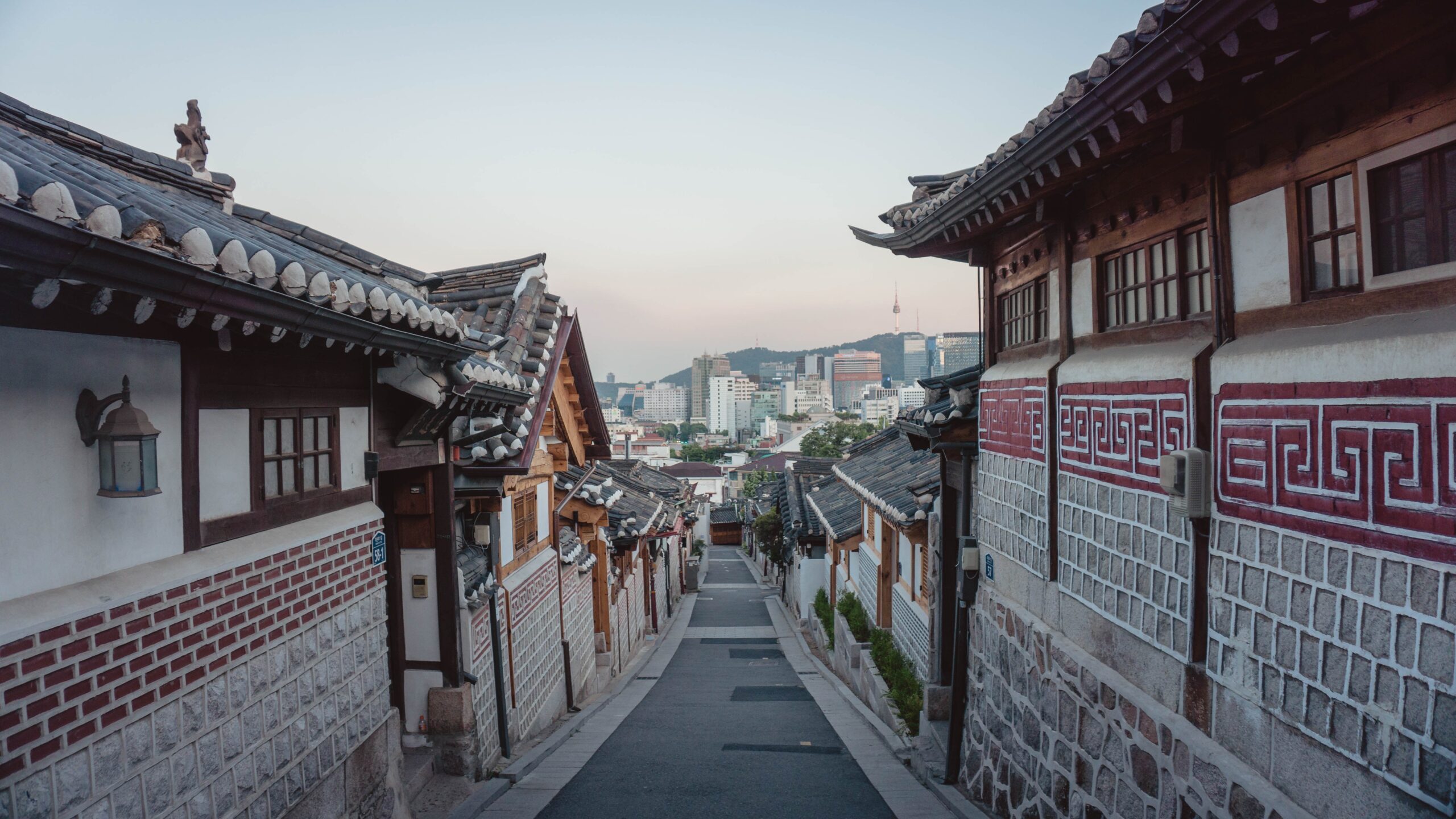 A narrow street lined with buildings in Seoul, South Korea, representing the past and future of the Korean Dream.