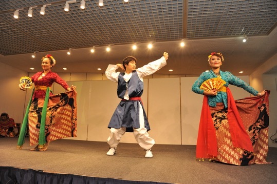 Multicultural dancers performing on stage.