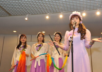A multicultural group of women singing at the One Family Festival 2023 gallery.