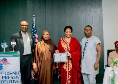 A group of people from Nigeria posing for a photo with a certificate, symbolizing the deepening democracy in the country.
