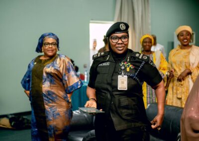 A group of women in uniform, including a police officer, proudly representing Deepening Democracy Nigeria.