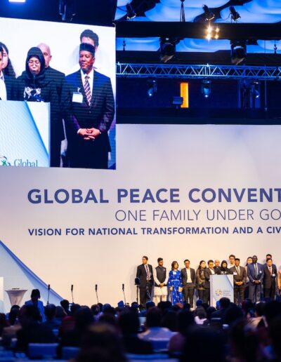 A group of people standing on a stage at the Global Peace Convention.