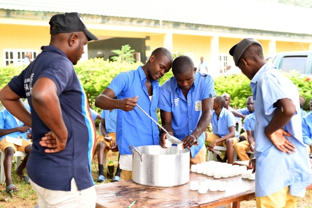A group of youth in Nigeria are preparing food on a table, participating in skills acquisition training programs that have the power to change lives.