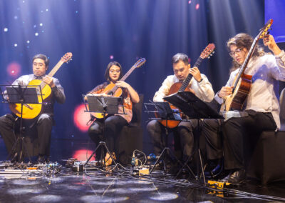 A group of people playing guitars at the 2023 Awards Gala.