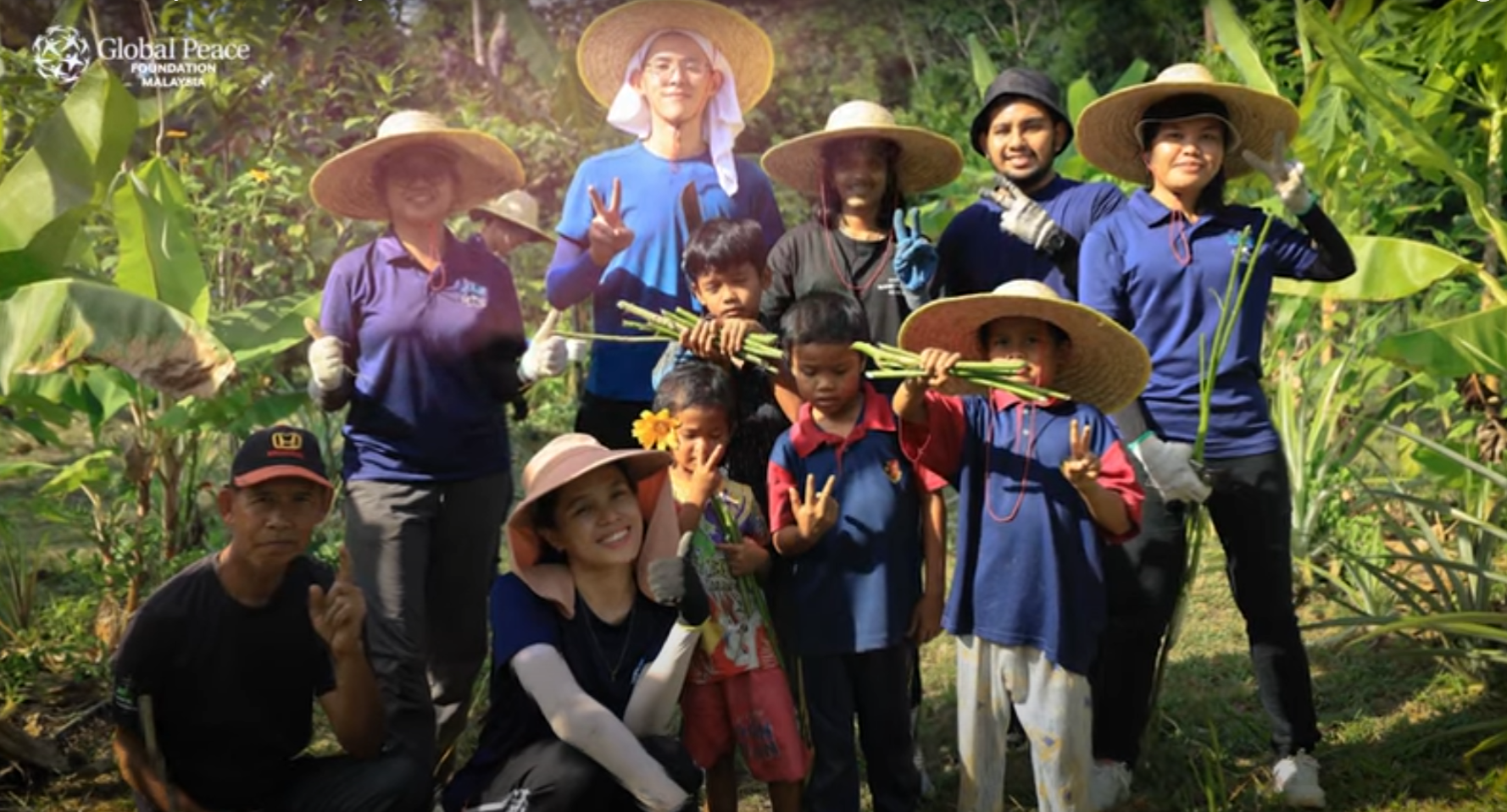 A group of people in Malaysia wearing hats and posing for a photo, capturing "Our Story" in a video.