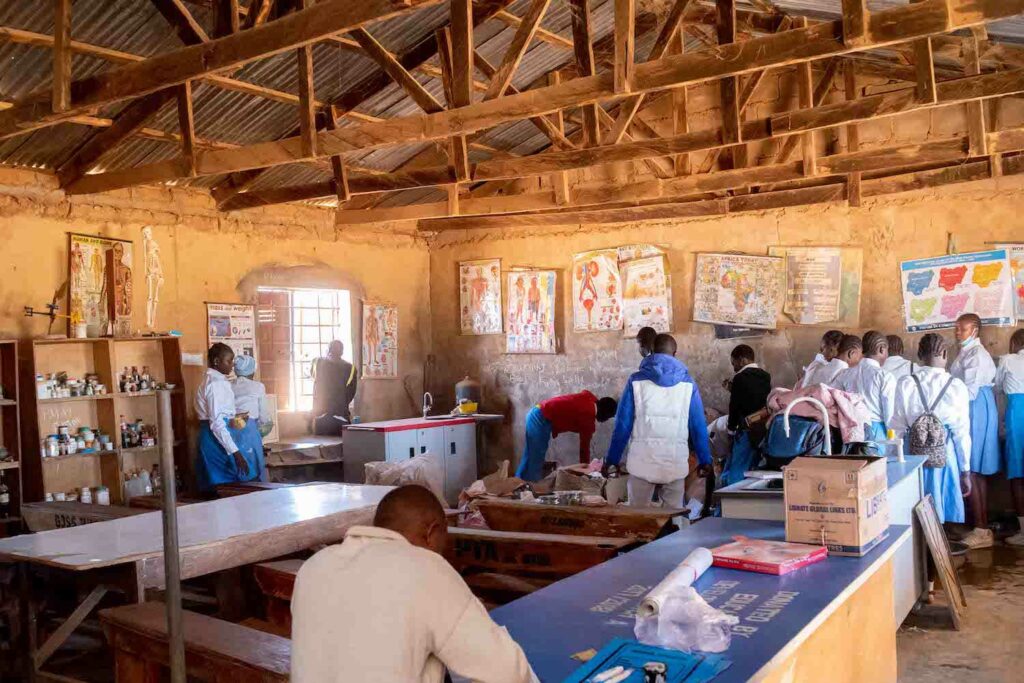 A group of people working in a classroom on Bukuru community service projects.