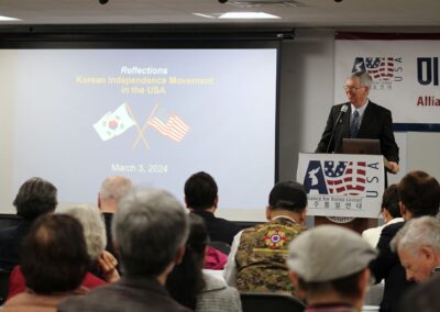 Speaker addressing an audience at a forum about the Korean independence movement in the USA on March 3, 2024, focusing on the significance of the March 1 Movement.