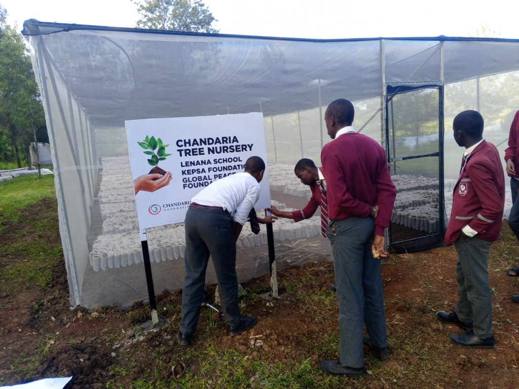Students and a teacher engaging in an activity at the Chandaria Tree Nursery at Lenana School, Kenya, supported by the KEPSA Foundation for sustainable development.