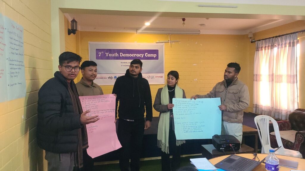 Group of innovative leaders displaying posters at a youth democracy camp.