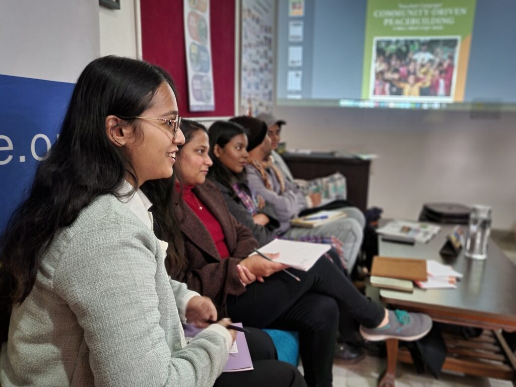 Women attentively participating in a PeaceHub seminar or workshop.