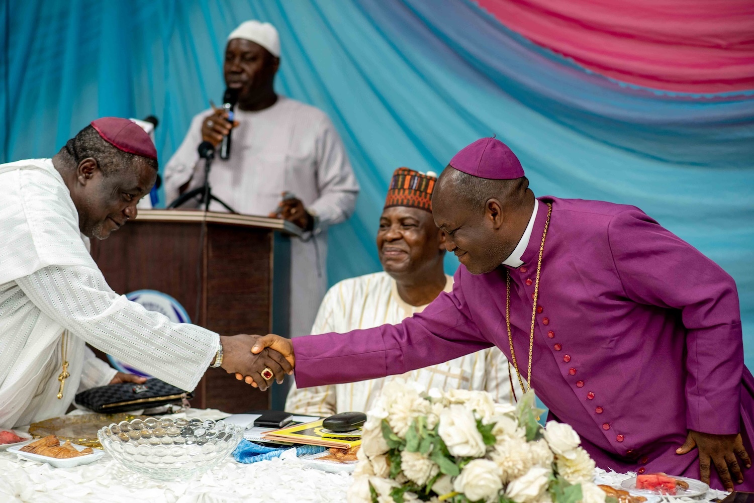 Nigerian men shaking hands.