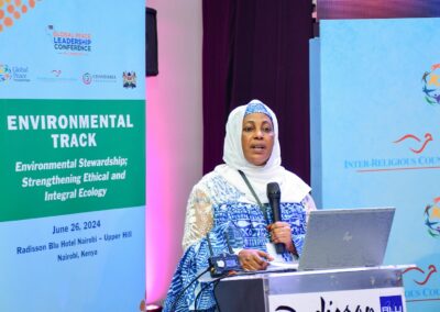 A speaker in a blue and white outfit stands at a podium during the Environmental Track at GPLC Africa 2024 on June 26, in Nairobi, Kenya, discussing environmental stewardship.