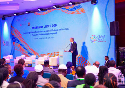 A speaker addresses an audience at the GPLC Africa 2024 conference in Nairobi, Kenya, themed "One Family Under God," focusing on African renaissance, freedom, peace, and sustainable development during the plenary session.