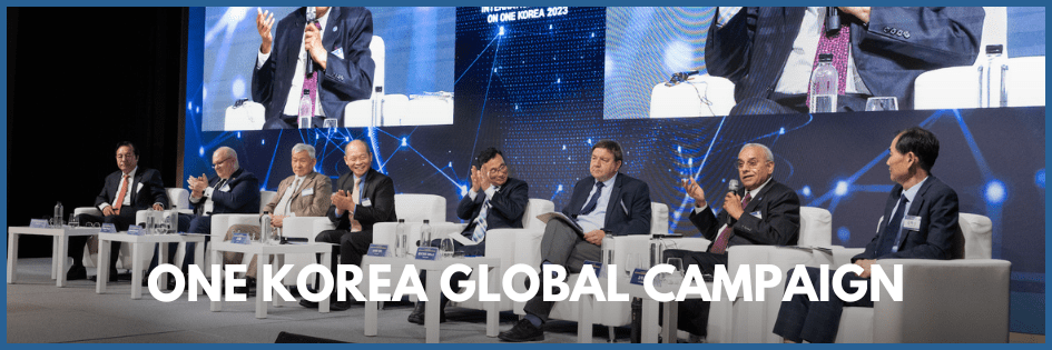 A panel of eight people is seated on stage at the 