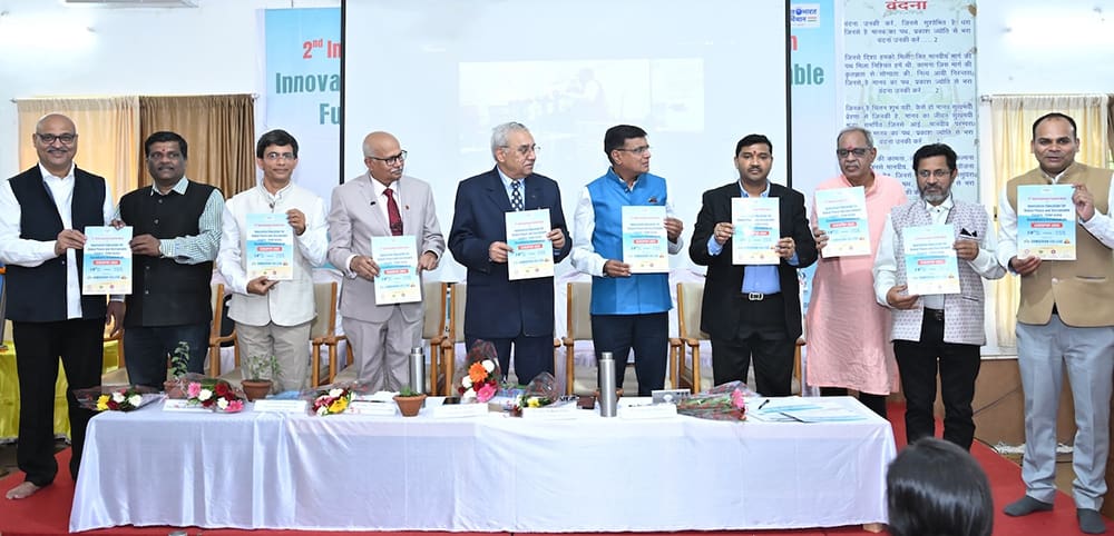 A group of people stands on a stage holding books or papers, advocating for a sustainable future. A table in front showcases flowers and candles, symbolizing the harmonious blend of nature and knowledge.