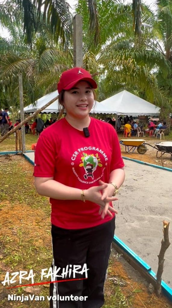A person in a red cap and shirt stands outdoors near a tent, surrounded by palm trees. Text on the image reads 