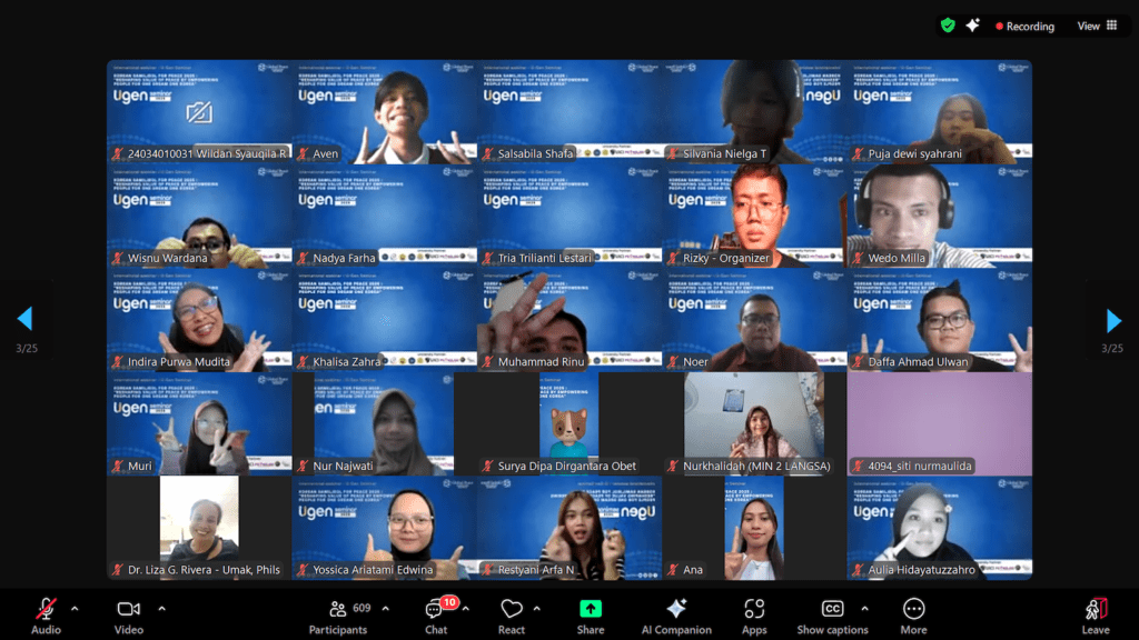 In a vibrant virtual meeting reminiscent of the Samiljeol Movement, numerous participants appear in a grid format on a blue background. Each is in individual video frames, some waving or making gestures, embodying a lively spirit of unity and action.