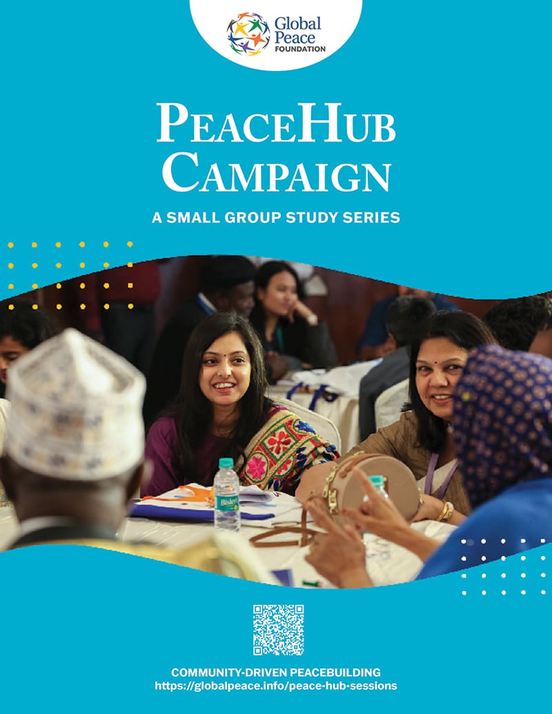 A group of people sitting at tables, engaged in a discussion, with a banner overhead reading "PeaceHub Campaign" for a small group study series by the Global Peace Foundation.