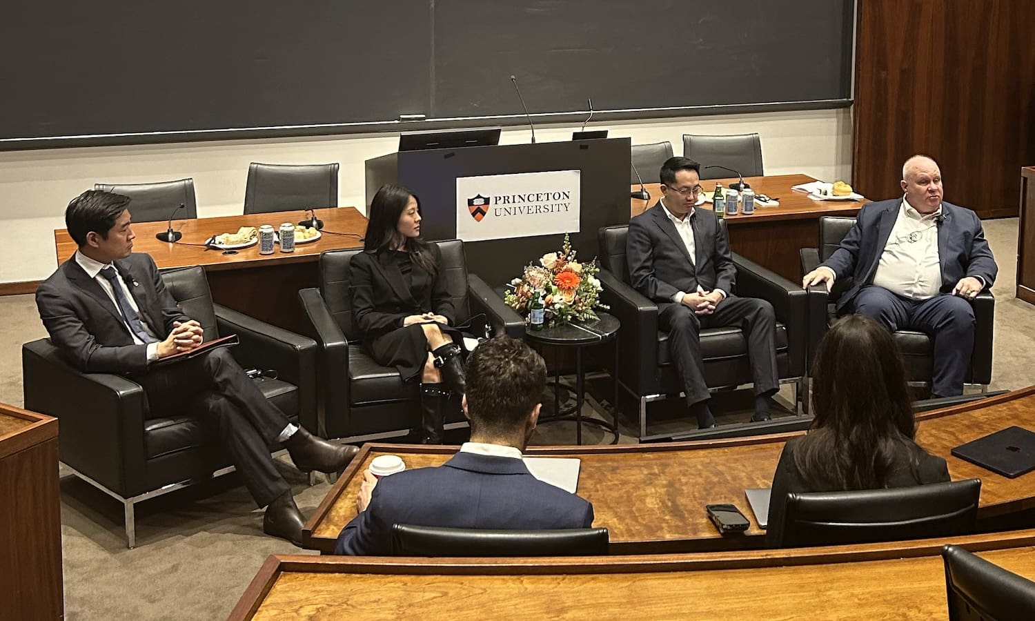 Four panelists seated and speaking in front of a Princeton University podium discuss Youth Leadership and the Korean Dream, with audience members listening in a lecture hall setting.