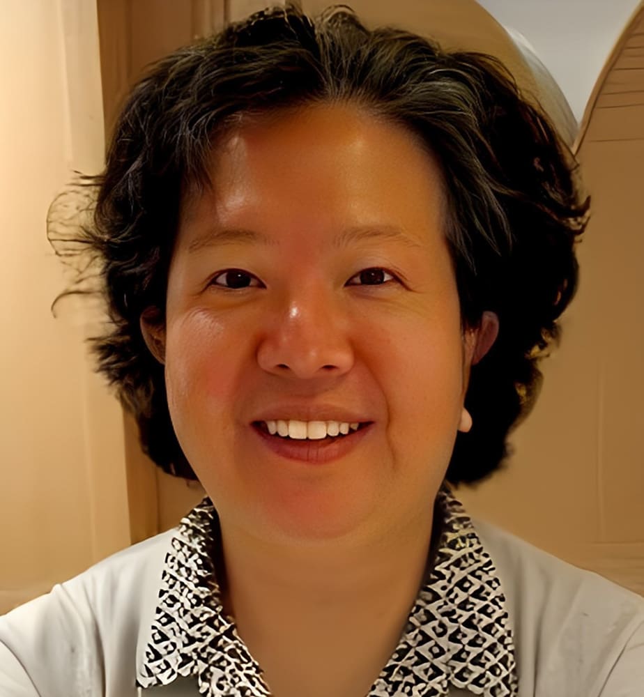 Danning Wang Dr. Danning Wang, with short, wavy dark hair and a patterned collared shirt, smiles at the camera indoors.