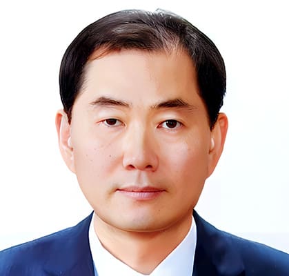 A1. Opening Session 1. Baeksan Kim Baek-san Kim, a man with short dark hair wearing a navy suit and white shirt, poses for a formal headshot against a plain white background.
