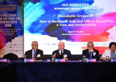 Five panelists sit at a table during the "Role of Northeast Asia and USA in Supporting a Free and Unified Korea" roundtable session on Day 2 of the International Forum on One Korea 2025.