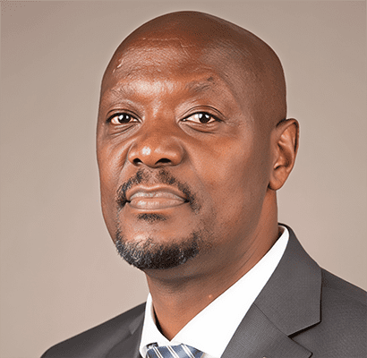 S2 Lessons Learned Latin America & Africa 7. Hon. Duncan Mathenge Jamil Mahuad, dressed in a dark suit jacket, white shirt, and striped tie, poses for a professional headshot against a plain background.