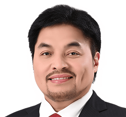 S5. Regional Solidarity for Korean Unification 6. Hon. Abdulgani M. Macatoman Abdulgani M. Macatoman, a man with short black hair, a trimmed beard and mustache, wearing a dark suit, white shirt, and red tie, smiles in front of a plain white background.