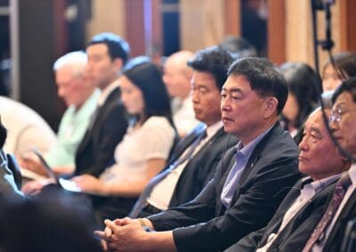 A group of people in business attire sit in rows, attentively listening at the Day 2 session of the One Korea 2025 International Forum.