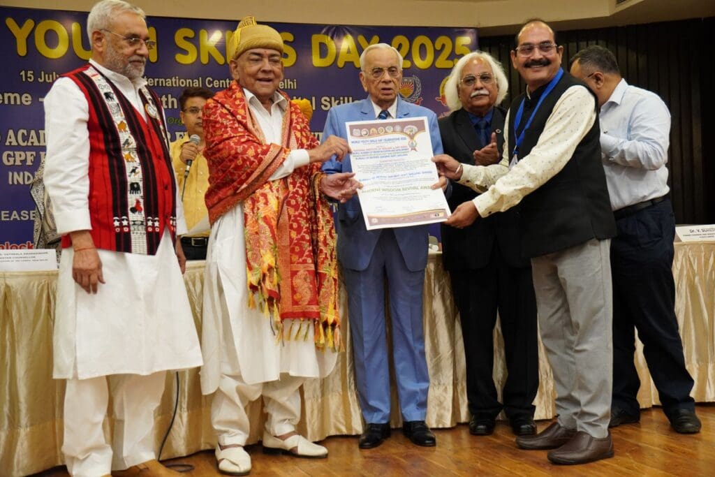 A group of five men stand on stage at a World Youth Skills Day 2023 event, with one man receiving a certificate from another while others observe and smile, celebrating youth skills for a sustainable future.