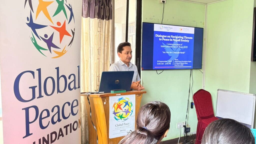 A man stands at a podium giving a presentation titled 