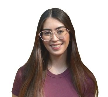 A young woman with long brown hair and glasses, wearing a maroon t-shirt, smiles at the camera against a white background, embodying the spirit of global responsibility ahead of Brazil COP30.