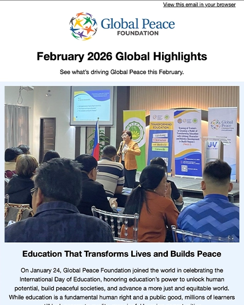 A woman speaks to a seated audience at a Global Peace Foundation event, with banners and a projector screen visible in the background.