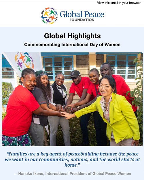 A group of women stand together, smiling and stacking hands, under a banner for Global Peace Foundation's International Day of Women event.